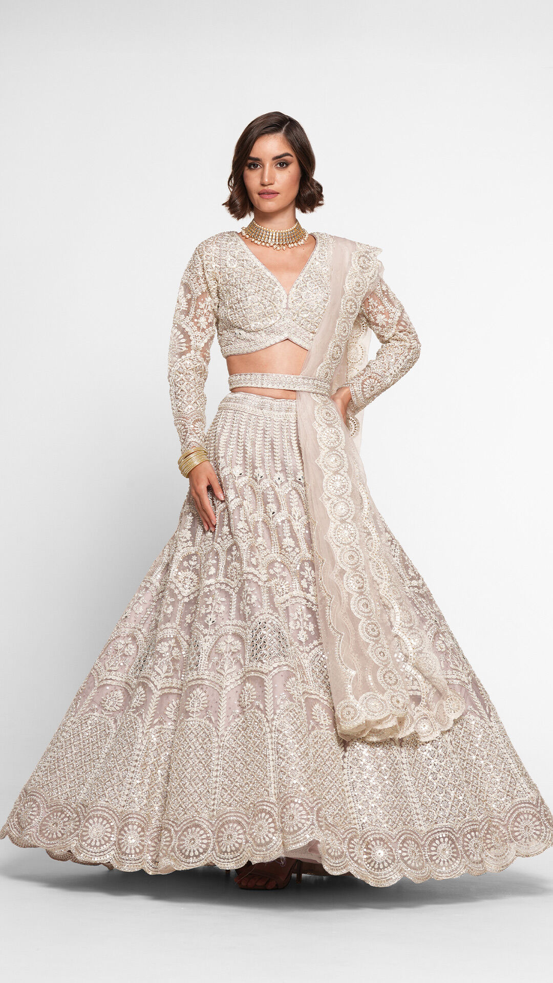 Bride showcasing a voluminous white net lehenga with cancan layering
