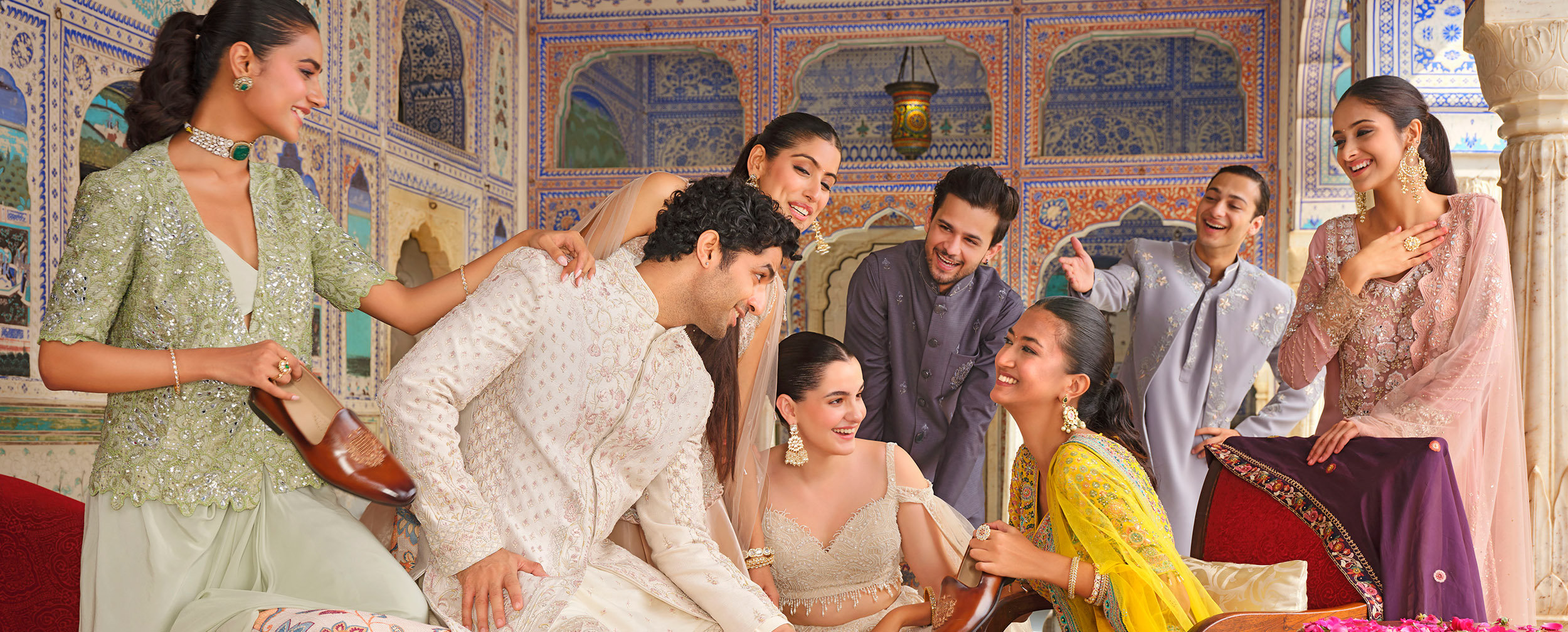 A group of people wearing stylish lehengas and kurtas at a festive wedding celebration. A group of people wearing stylish lehengas and kurtas at a festive wedding celebration.